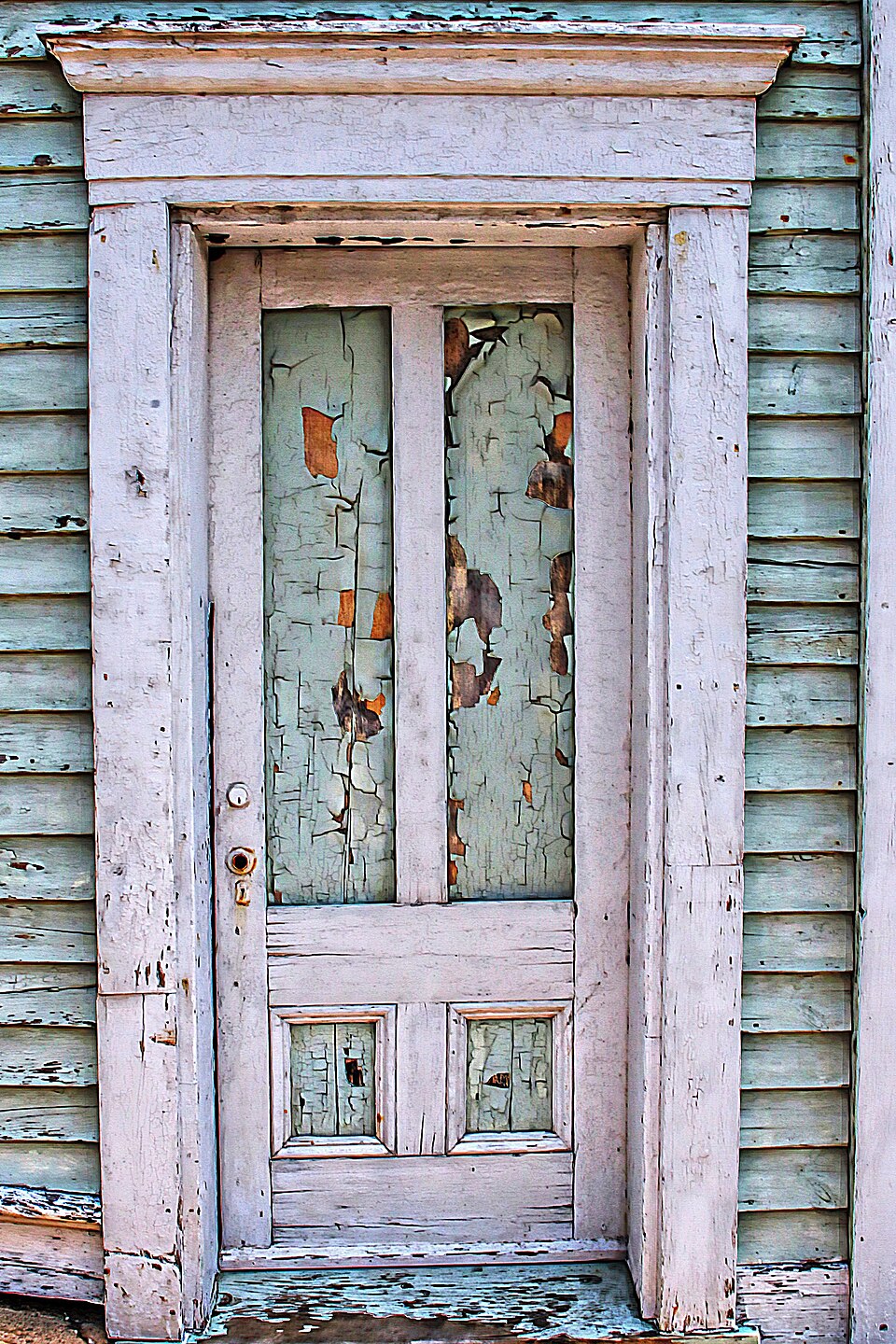 Old wooden door with peeling paint — the kind of surface laser cleaning restores without damaging the wood underneath